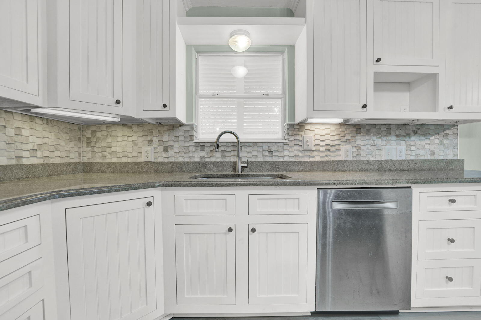 93 Beachfront Trail Santa Rosa Beach, FL 32459 - Photo 11 of 42 a kitchen with granite countertop white cabinets and sink