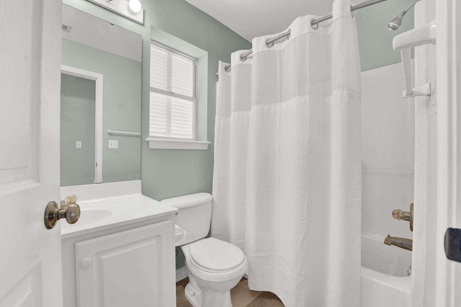 93 Beachfront Trail Santa Rosa Beach, FL 32459 - Photo 14 of 42 a bathroom with a sink a toilet a mirror and shower curtain