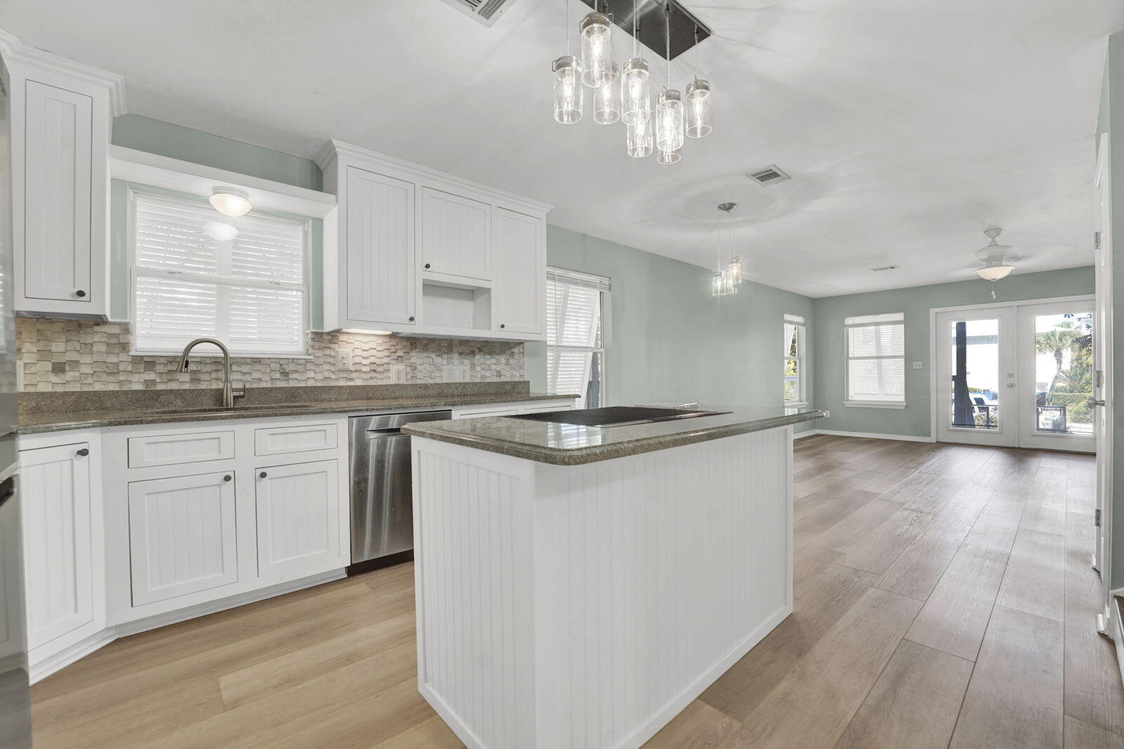 93 Beachfront Trail Santa Rosa Beach, FL 32459 - Photo 9 of 42 a kitchen with stainless steel appliances granite countertop a lot of counter space and wooden floors