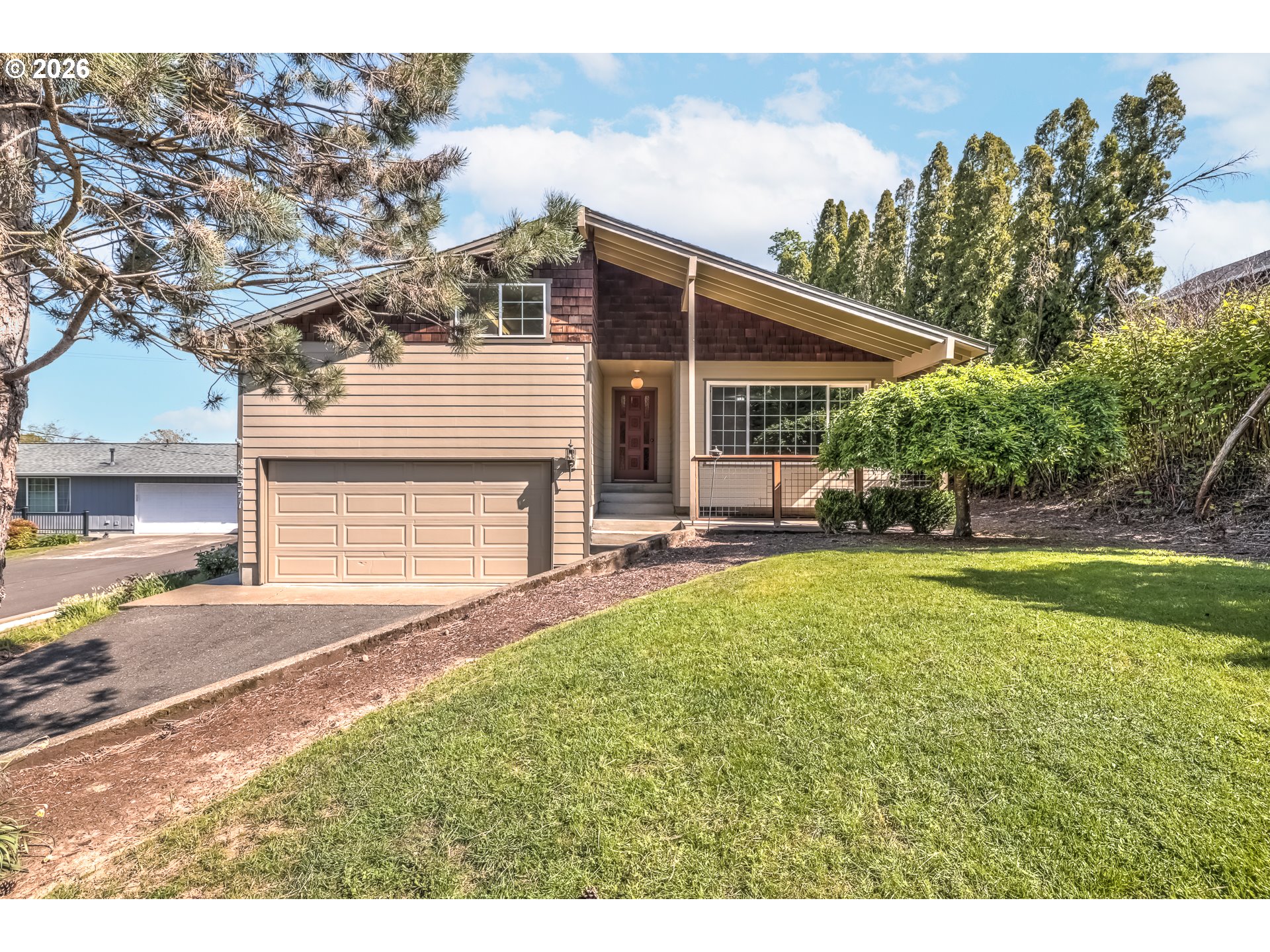 a view of a house with backyard and sitting area