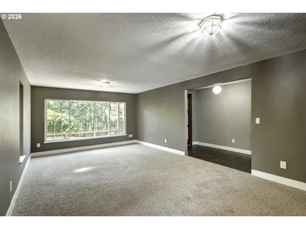 a view of a livingroom with a ceiling fan and window