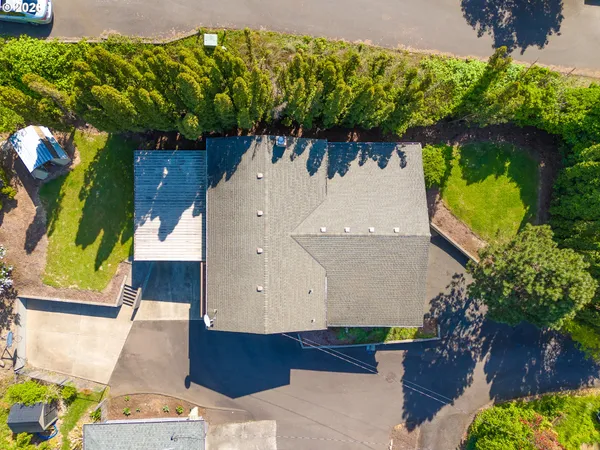an aerial view of a house with a yard
