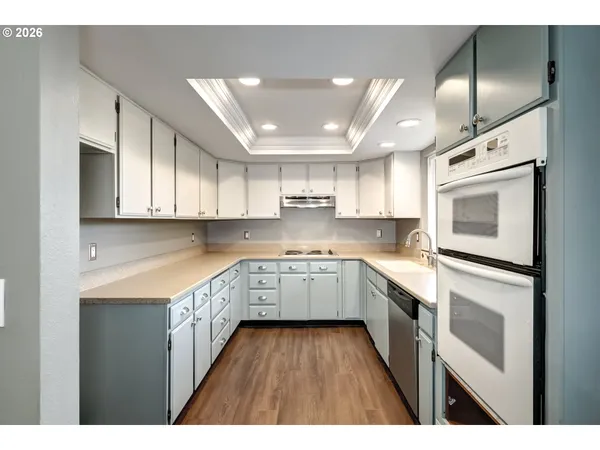 a kitchen with cabinets and white appliances