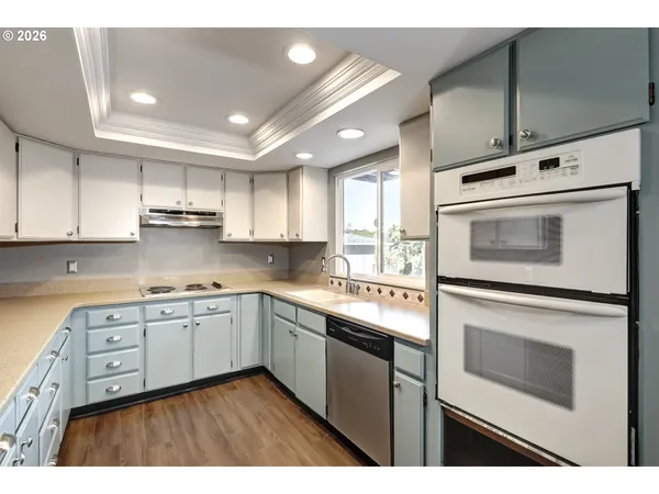 a kitchen with stainless steel appliances granite countertop a stove sink and cabinets