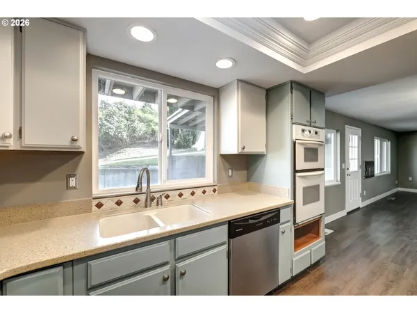 a kitchen with a sink and a refrigerator