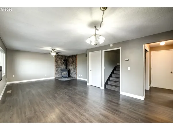 a view of an empty room and wooden floor