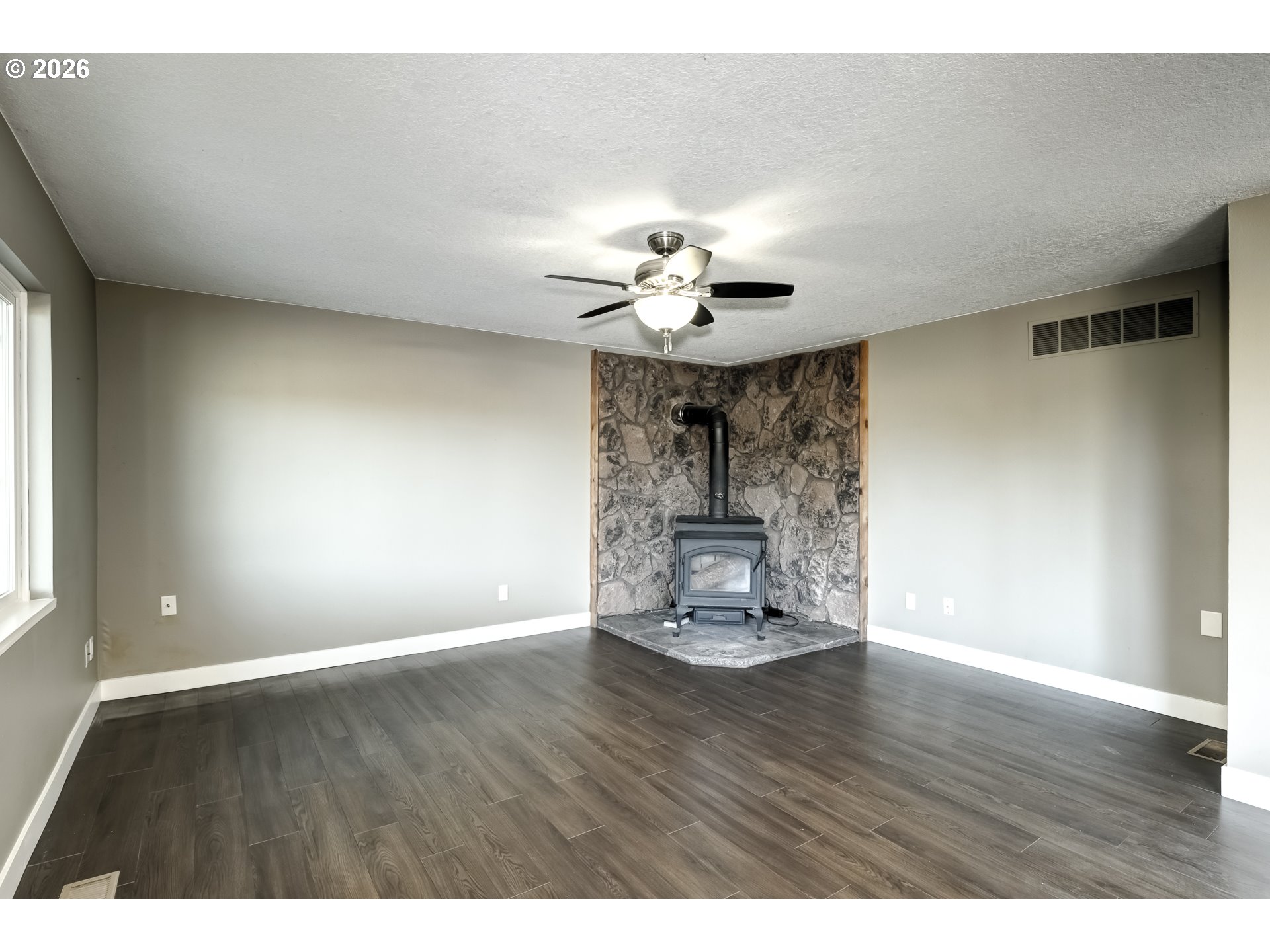 42371 Northwest Banks Road Banks, OR 97106 - Photo 10 of 42 a view of an empty room with a window and wooden floor