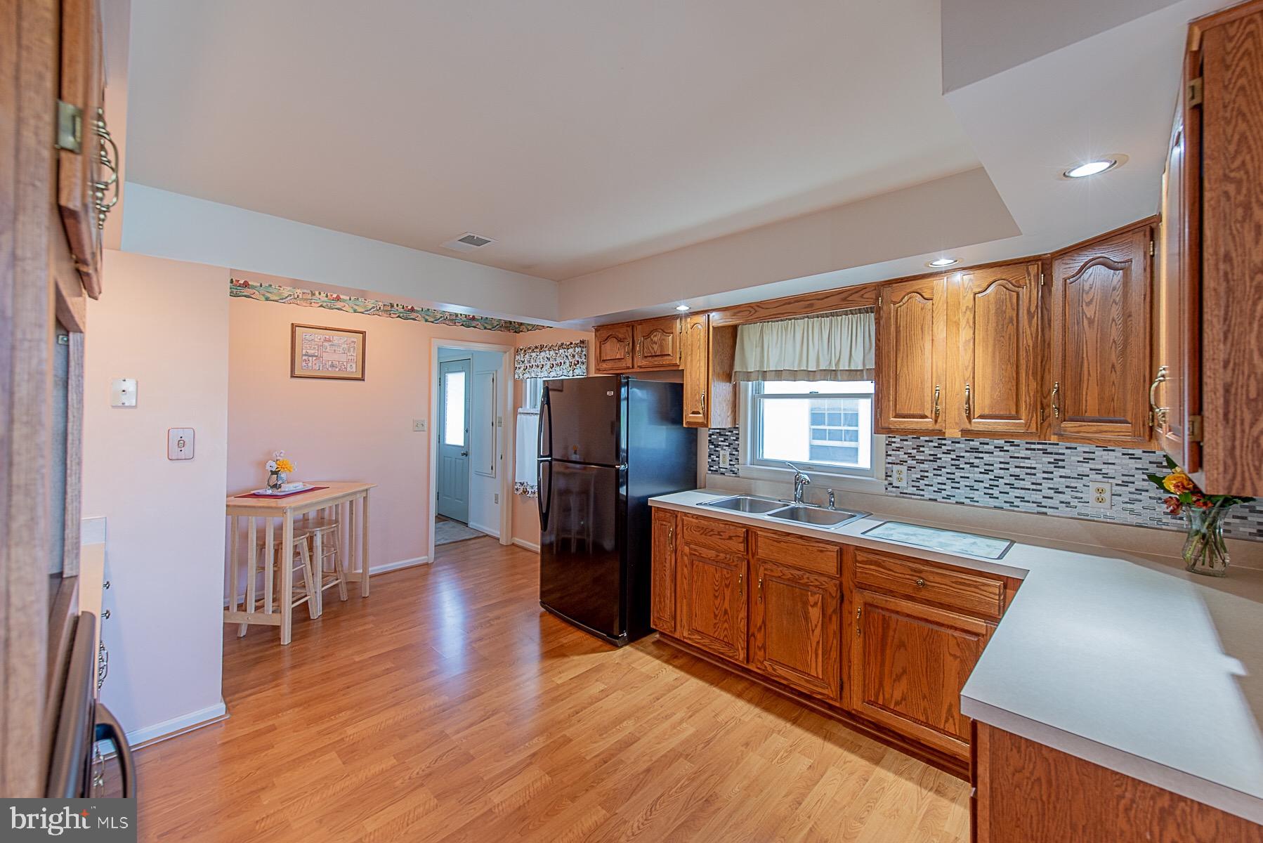 4000 Bark Hill Road Union Bridge, MD 21791 - Photo 13 of 61 a kitchen with stainless steel appliances granite countertop a refrigerator a sink dishwasher a stove and white countertops with wooden floor