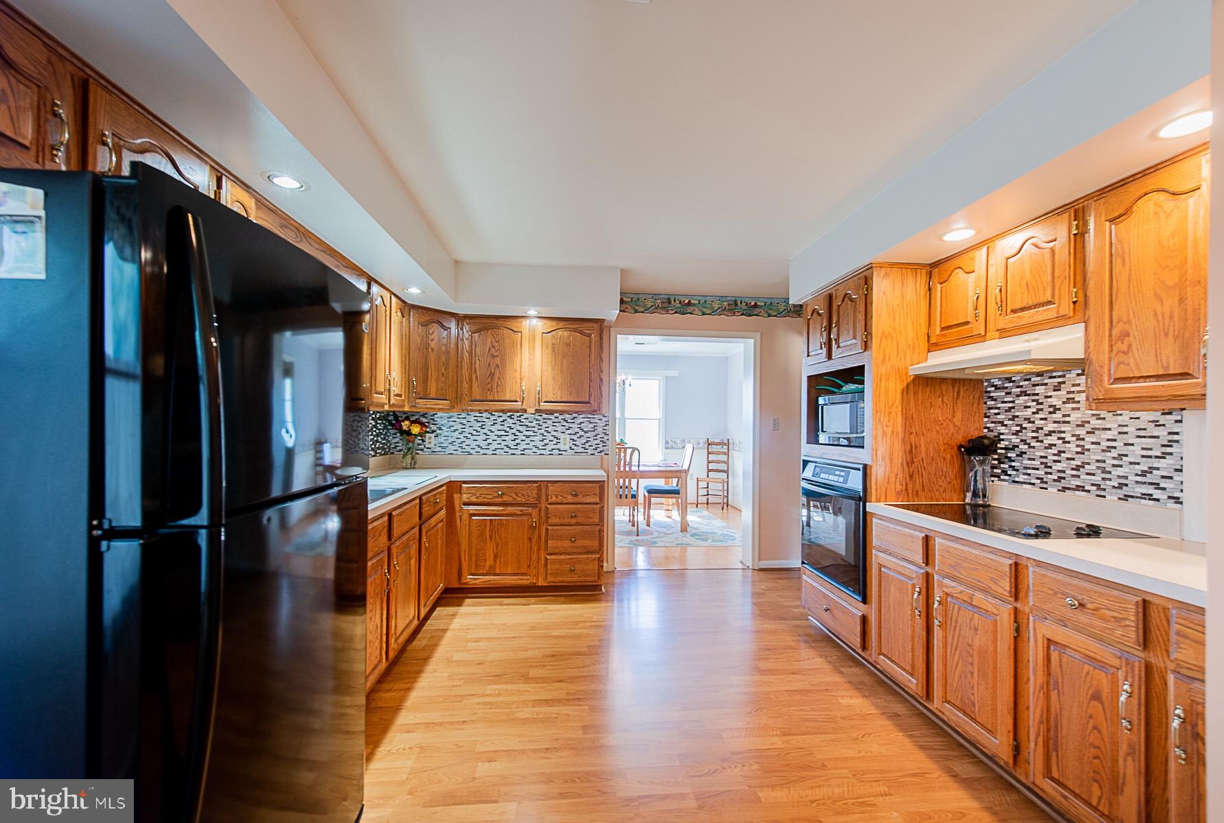 4000 Bark Hill Road Union Bridge, MD 21791 - Photo 18 of 61 a kitchen with stainless steel appliances granite countertop a refrigerator a stove and a wooden cabinets