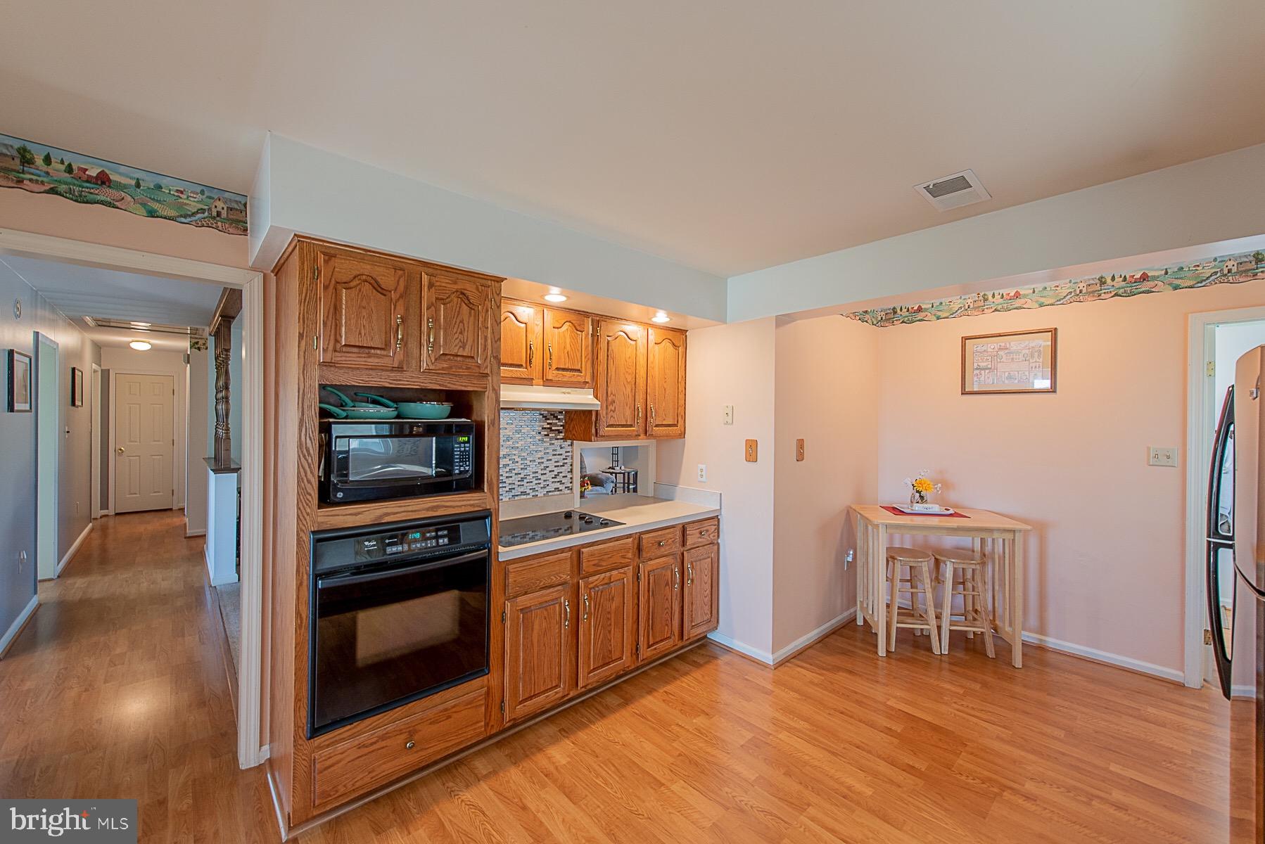 4000 Bark Hill Road Union Bridge, MD 21791 - Photo 19 of 61 a kitchen with stainless steel appliances a stove a refrigerator and a fireplace