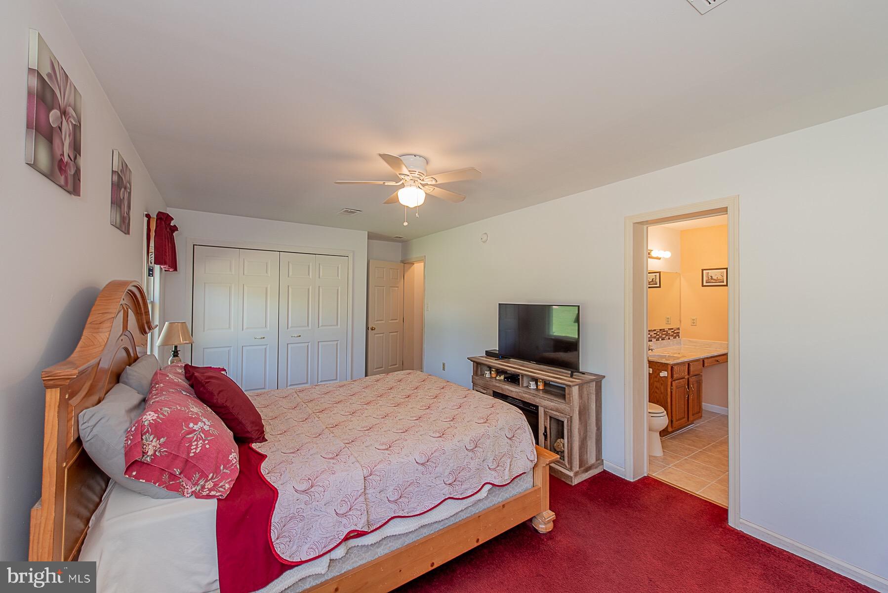 4000 Bark Hill Road Union Bridge, MD 21791 - Photo 35 of 61 a bedroom with a bed and a chandelier