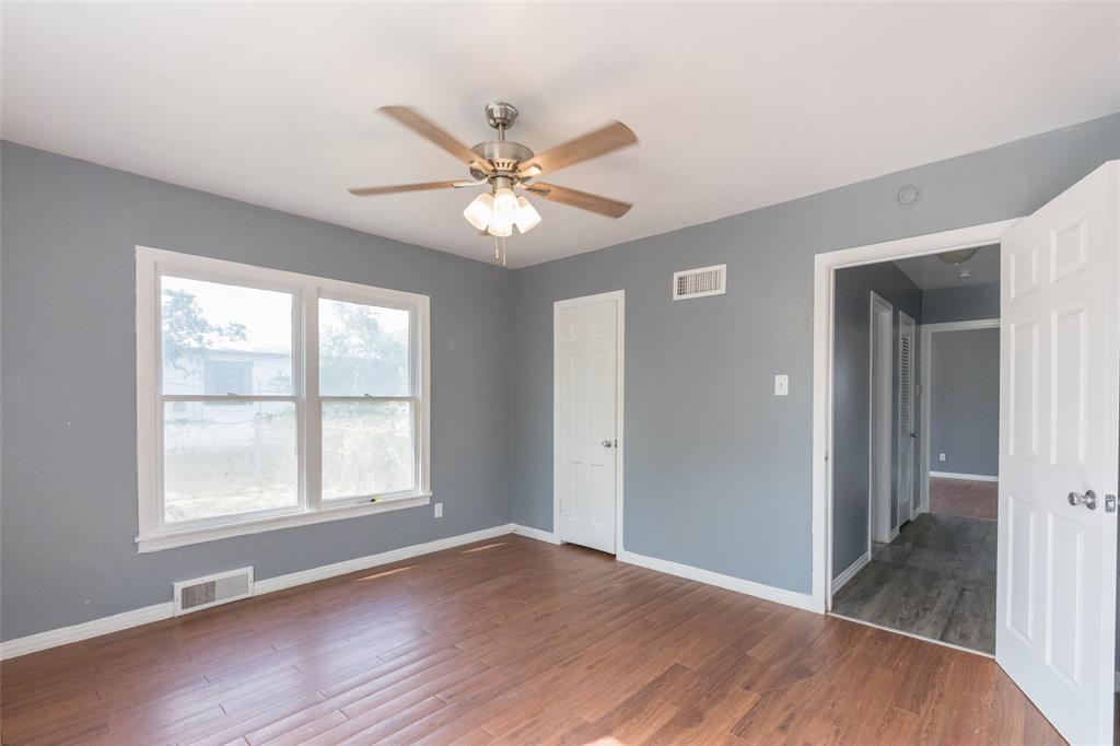 2841 Old Anson Road Abilene, TX 79603 - Photo 14 of 34 This room features hardwood flooring, a ceiling fan with integrated lighting, and two windows providing natural light