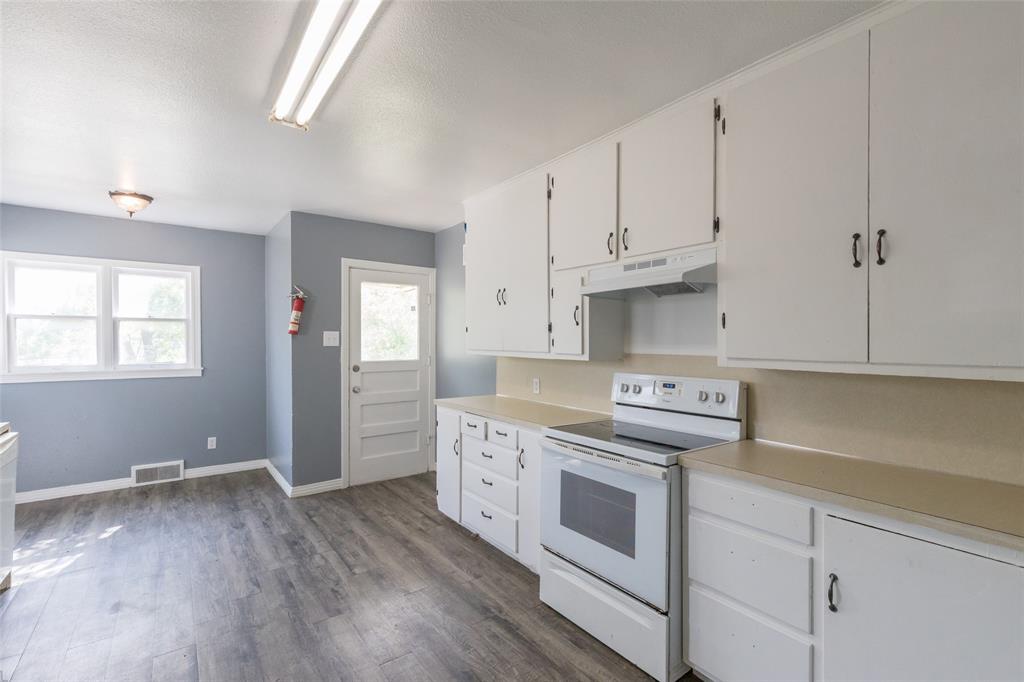 2841 Old Anson Road Abilene, TX 79603 - Photo 16 of 34 The kitchen features white cabinetry, an electric range, and light-colored countertops