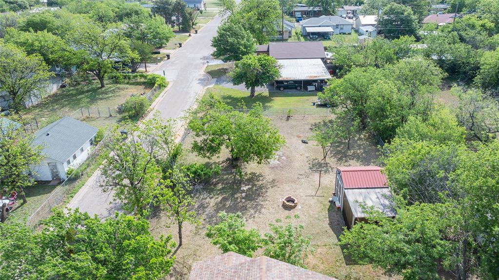 2841 Old Anson Road Abilene, TX 79603 - Photo 2 of 34 The property offers a generous outdoor area with a visible fire pit and a shed featuring a red metal roof