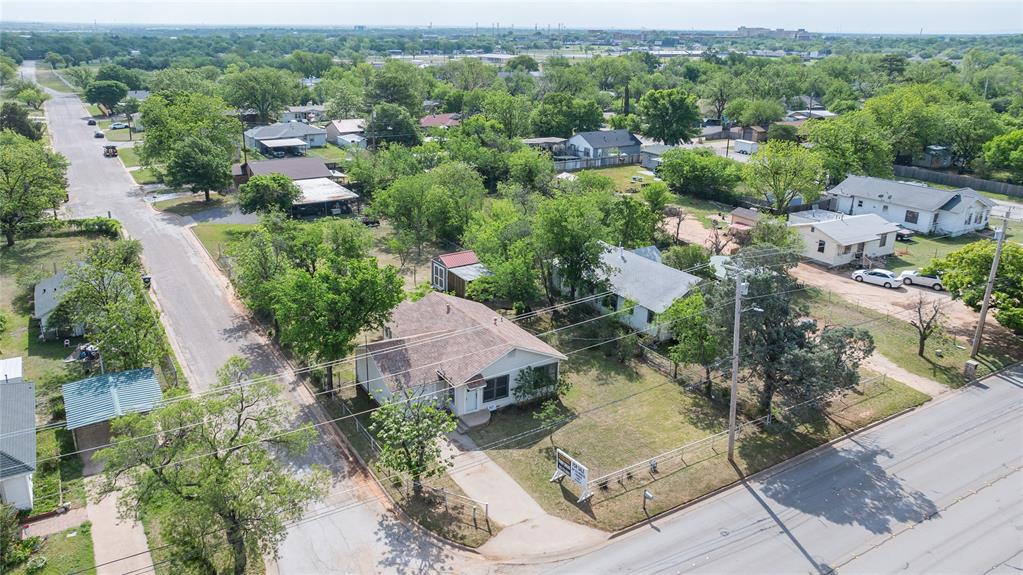 2841 Old Anson Road Abilene, TX 79603 - Photo 23 of 34 The property is situated on a corner lot with a green lawn and mature trees, offering a clear view of the surrounding neighborhood street