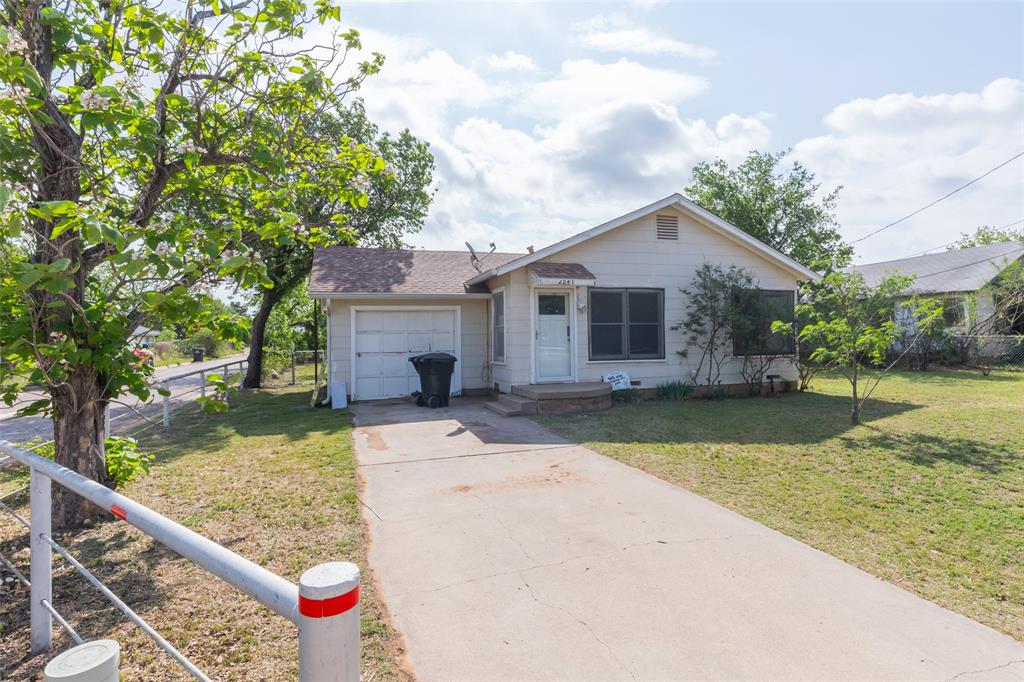 2841 Old Anson Road Abilene, TX 79603 - Photo 26 of 34 The property features a single-story residence with a light-colored exterior and a front-facing garage
