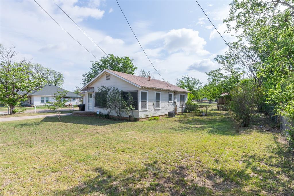2841 Old Anson Road Abilene, TX 79603 - Photo 27 of 34 The property features a single-story home with a light-colored exterior and a sloped roof
