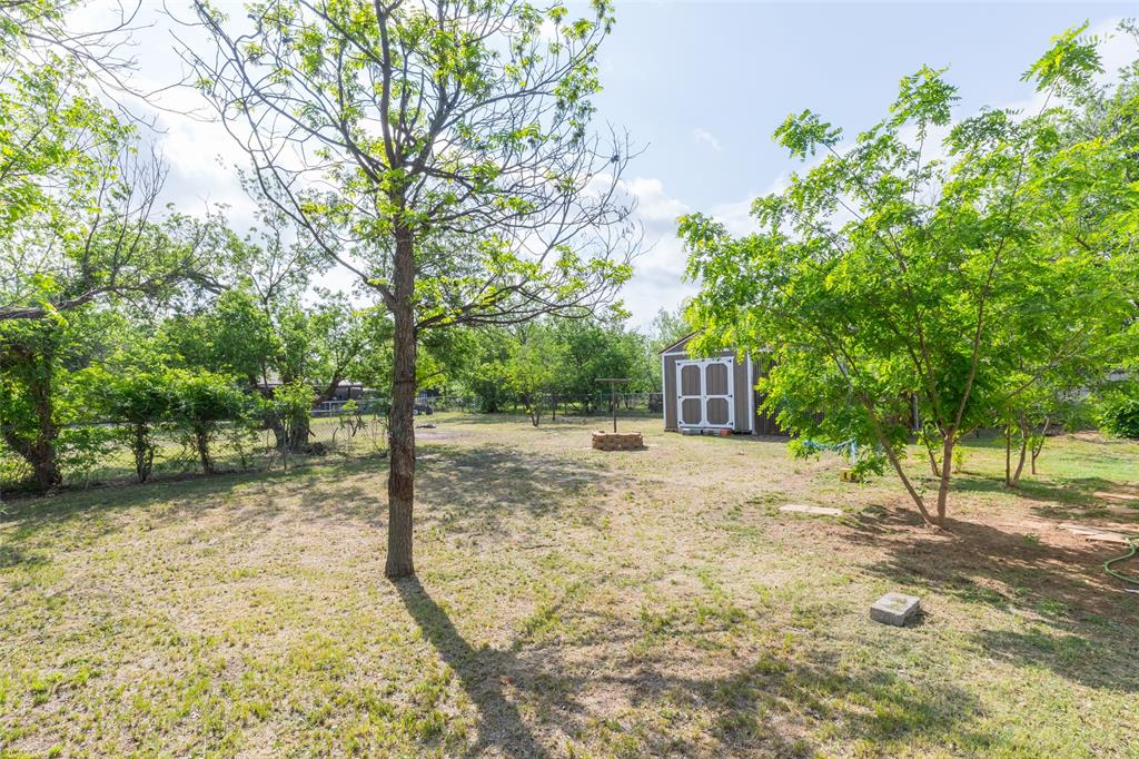 2841 Old Anson Road Abilene, TX 79603 - Photo 29 of 34 The property features an expansive yard with mature trees and a storage shed