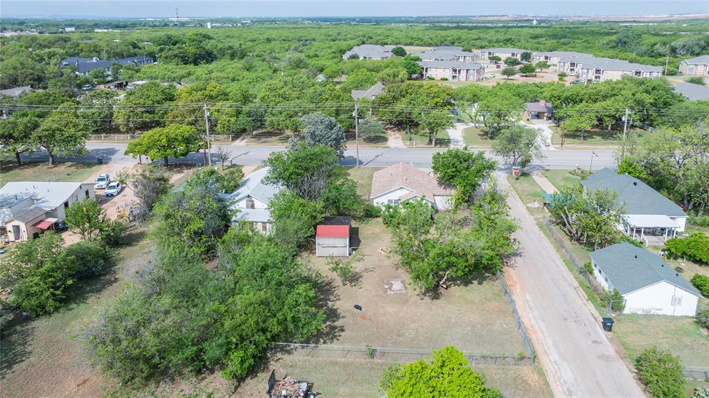 2841 Old Anson Road Abilene, TX 79603 - Photo 3 of 34 Aerial view showcasing the property with a visible red shed, surrounded by mature trees and a residential street
