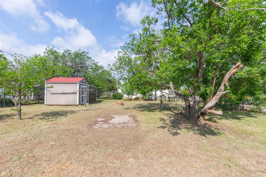 2841 Old Anson Road Abilene, TX 79603 - Photo 31 of 34 The property features a spacious yard with a storage shed and mature trees