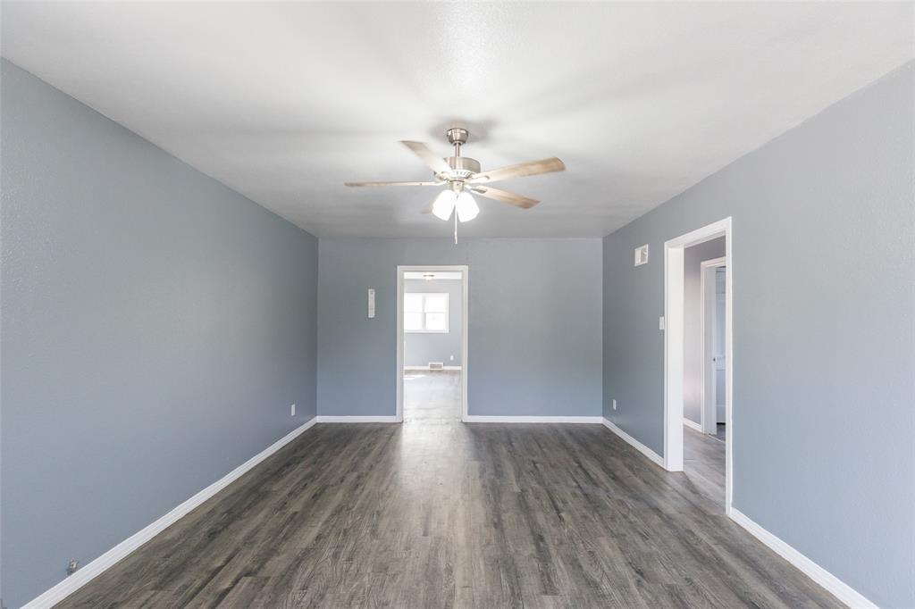 2841 Old Anson Road Abilene, TX 79603 - Photo 34 of 34 Expansive room featuring light gray walls, wood-style flooring, and a ceiling fan with integrated lighting