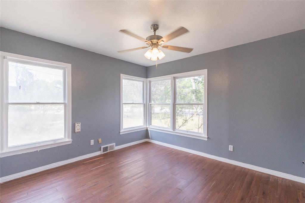 2841 Old Anson Road Abilene, TX 79603 - Photo 6 of 34 This bright room features hardwood flooring, a ceiling fan with integrated lighting, and walls painted in a neutral tone