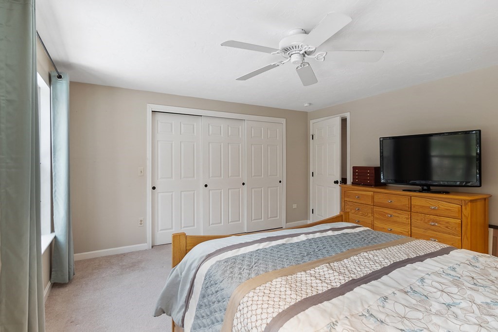 512 Ridgefield Circle, Unit C Clinton, MA 01510 - Photo 14 of 28 a bedroom with a bed and a flat screen tv