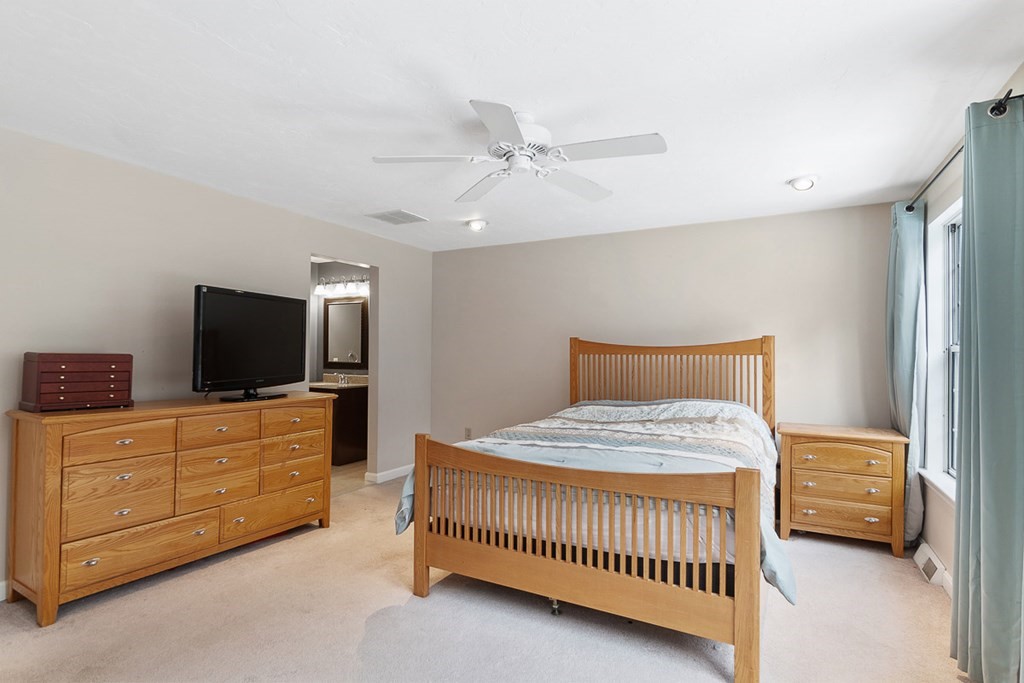 512 Ridgefield Circle, Unit C Clinton, MA 01510 - Photo 15 of 28 a bedroom with a bed and a flat screen tv in a room