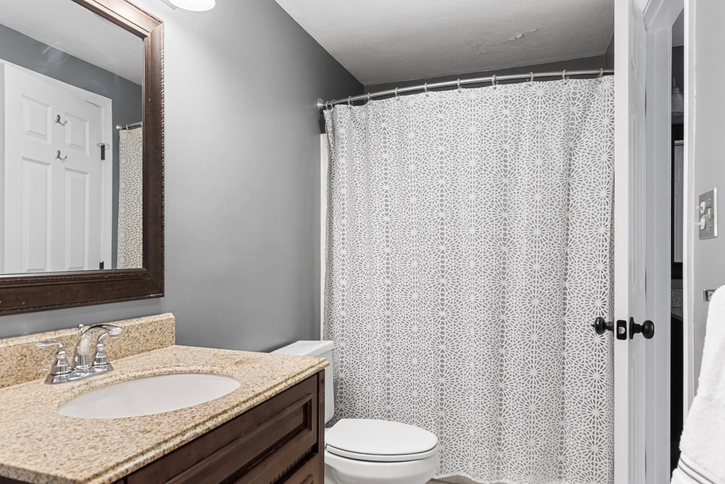 512 Ridgefield Circle, Unit C Clinton, MA 01510 - Photo 17 of 28 a bathroom with a granite countertop sink toilet and shower