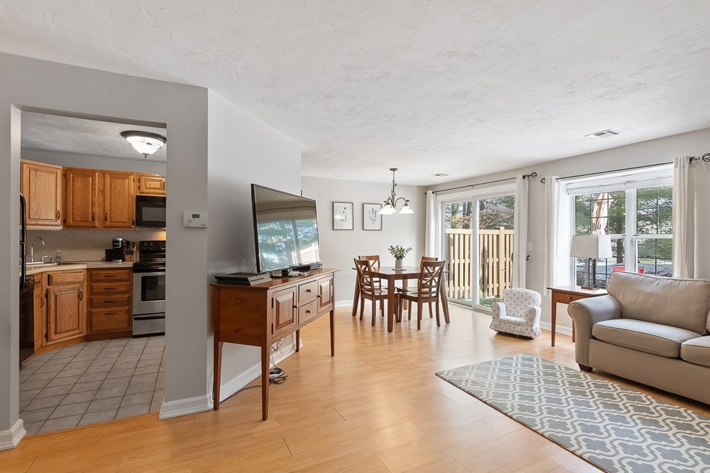 512 Ridgefield Circle, Unit C Clinton, MA 01510 - Photo 2 of 28 a living room with furniture wooden floor and a kitchen view