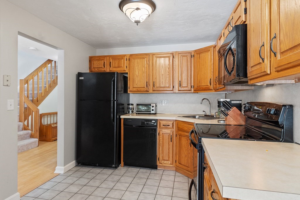 512 Ridgefield Circle, Unit C Clinton, MA 01510 - Photo 3 of 28 a kitchen with stainless steel appliances granite countertop a refrigerator stove top oven and sink