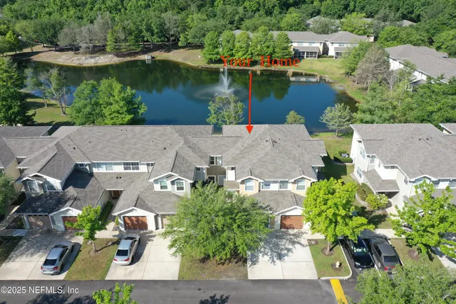 an aerial view of a house with a lake view