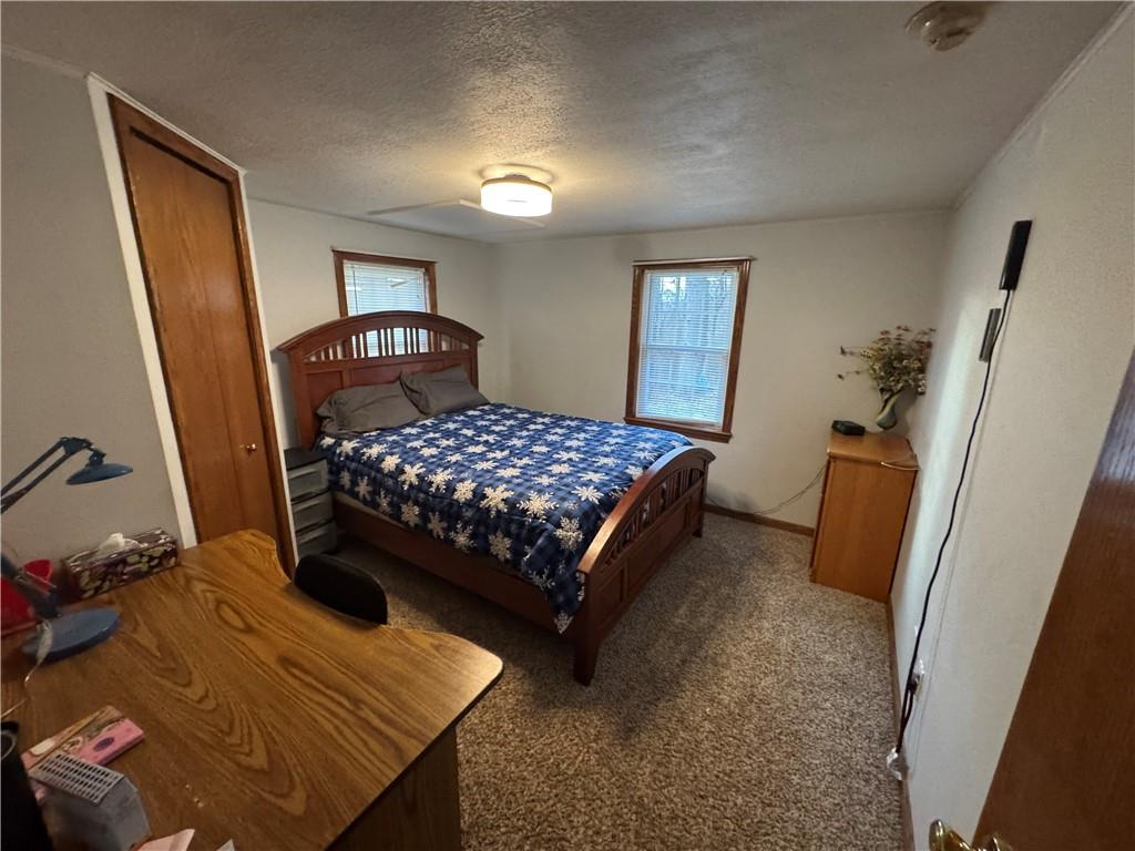526 East River Road Edinburg, PA 16116 - Photo 20 of 39 a bedroom with a bed and a mirror on dresser