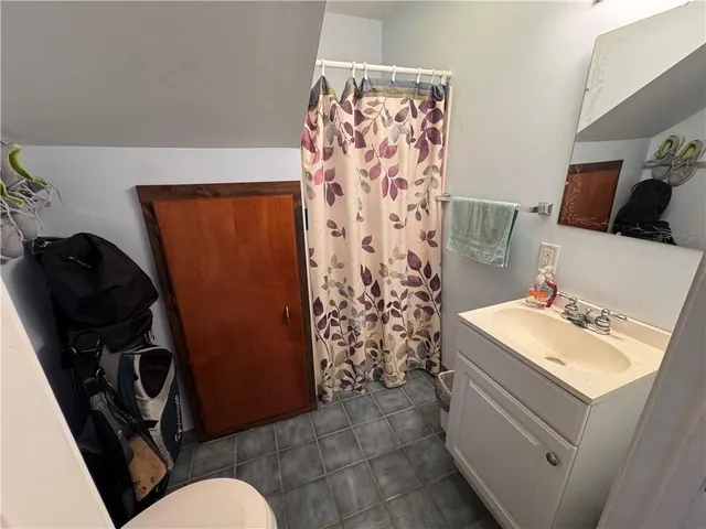 a white toilet sitting next to a small sink