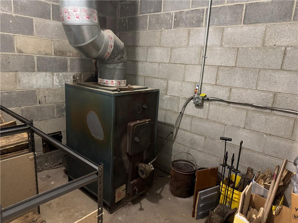 526 East River Road Edinburg, PA 16116 - Photo 33 of 39 a room with water heater and storage