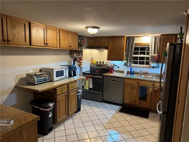 a kitchen with a sink a stove and refrigerator