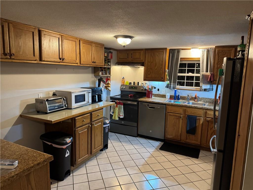 526 East River Road Edinburg, PA 16116 - Photo 8 of 39 a kitchen with a sink a stove and refrigerator
