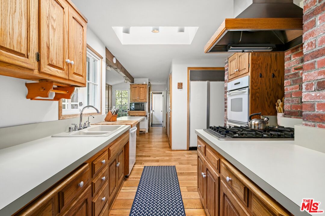 30800 Broad Beach Road Malibu, CA 90265 - Photo 19 of 31 a kitchen with stainless steel appliances a sink stove and cabinets