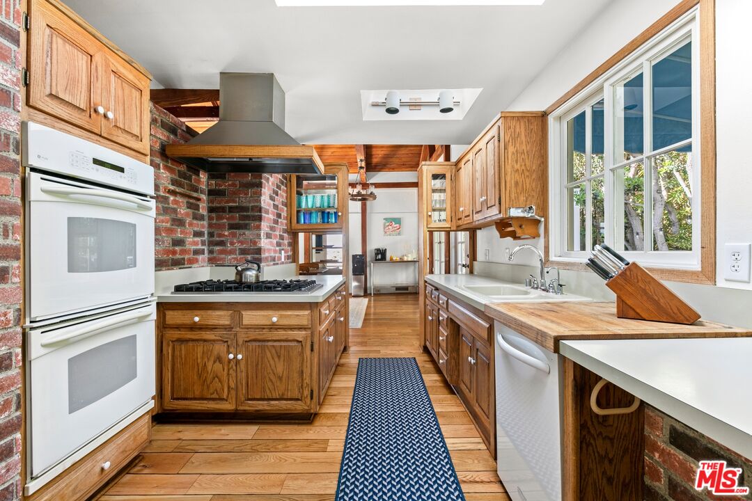 30800 Broad Beach Road Malibu, CA 90265 - Photo 20 of 31 a kitchen with stainless steel appliances granite countertop a stove and a sink