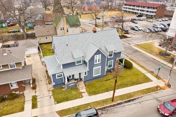 an aerial view of residential houses with outdoor space