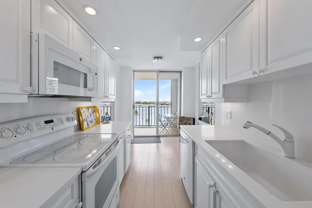 a kitchen with a sink stove top oven and cabinets