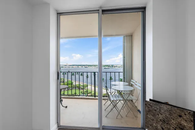 a view of a hallway with furniture and a window