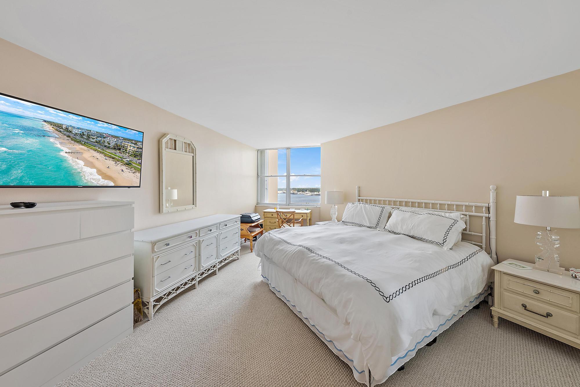 1801 South Flagler Drive, Unit 1206 West Palm Beach, FL 33401 - Photo 9 of 20 a bedroom with a bed and a flat screen tv