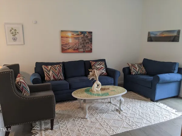 a living room with furniture and a rug