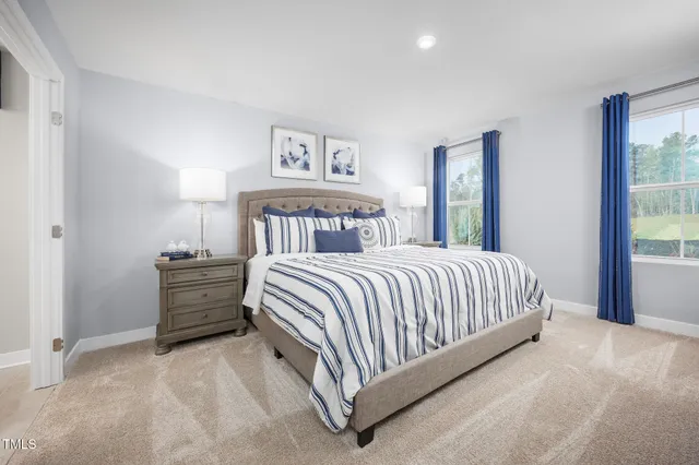 a bed sitting in a bedroom next to a window