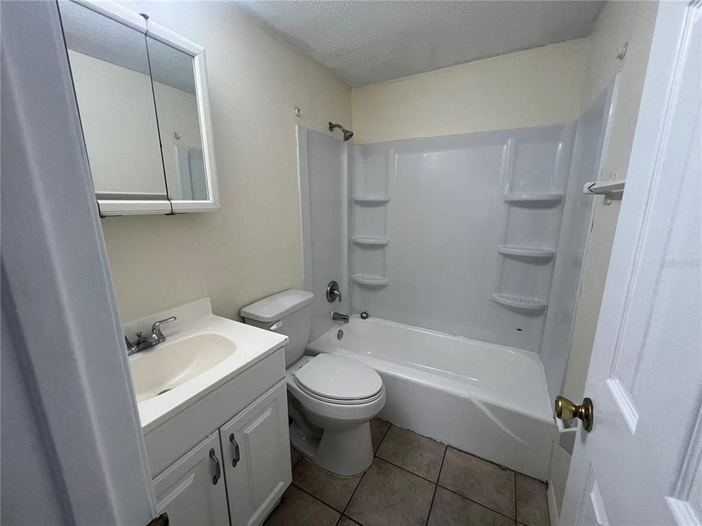 255 Pineapple Street, Unit 3 Englewood, FL 34223 - Photo 6 of 7 a bathroom with a sink a toilet and shower