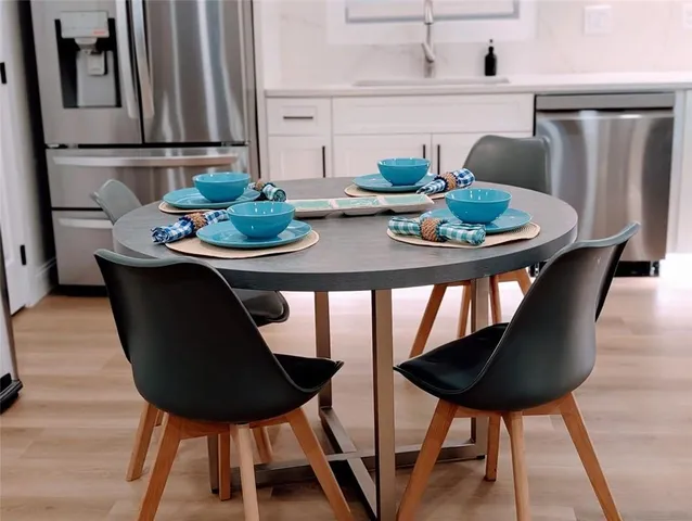 a dining room with furniture and wooden floor