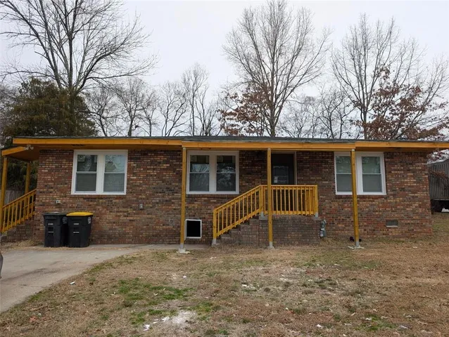 a front view of house with yard in front of it