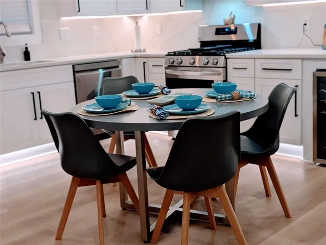 a kitchen with a dining table and chairs