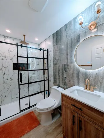 a bathroom with a sink toilet and shower